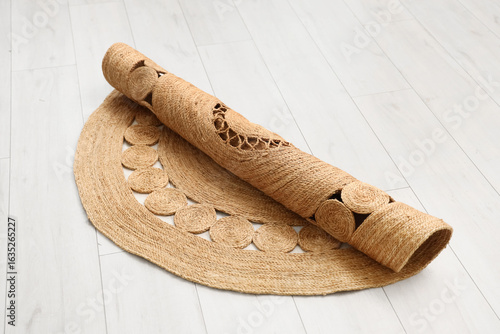 Rolled natural jute rug wit...
