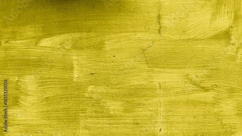 Close-up of yellow painted wall with visible brush strokes, cracks, and subtle imperfections on the surface.