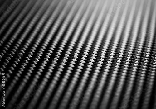 Carbon fiber texture, dark abstract background. High-tech, strong, sleek woven composite material ideal for automotive, aerospace, and modern design. Macro shot.