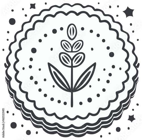 Monochrome graphic cookie with a botanical sprig and decorative star accents