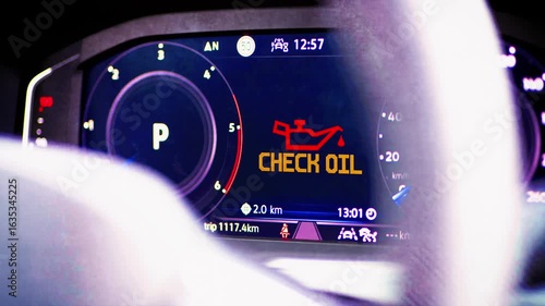 Digital cockpit of a modern car and a Check Oil warning light
