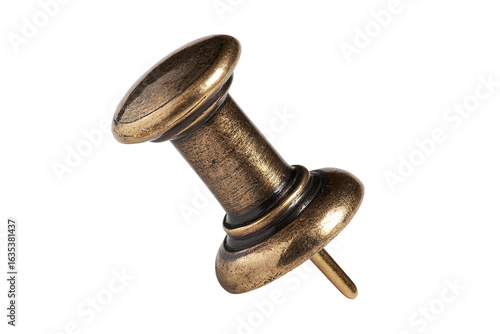 Close-up of a decorative antique-style push pin.  The pin's brass-colored metal is highlighted against a black background.  Rounded head and shank are visible