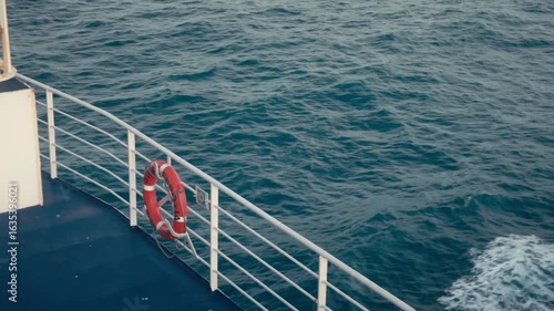 A life ring on the edge of a boat as it sails through the sea