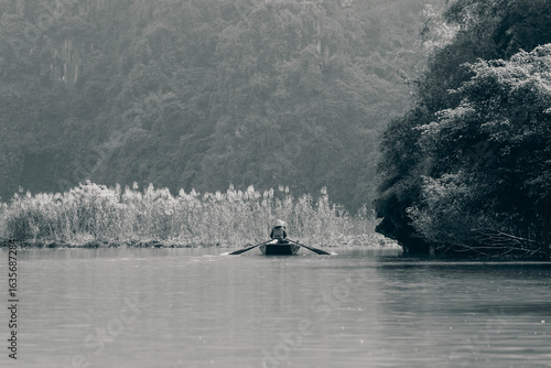 black and white photo of a boatman in Tam Coc, Ninh Binh
