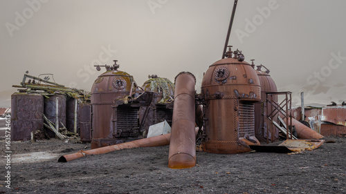 Remains of rusting whaling station in Deception Island Antarctica on the background of cloudy sky