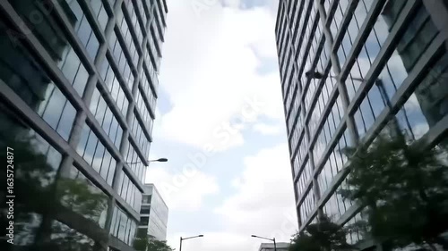 Modern Urban Street with Tall Skyscrapers and Open Blue Sky