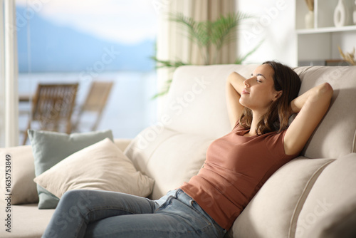 фотографія Single relaxed woman resting sitting on a sofa at home