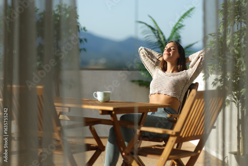 Bild auf Leinwand Woman relaxing sitting in a terrace in a house outdoors