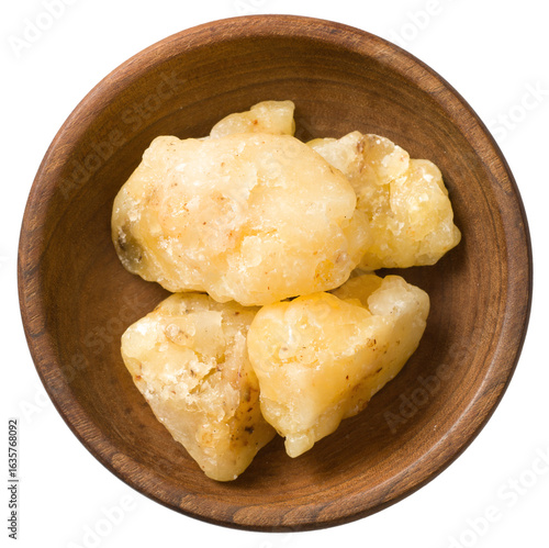Gum elemi in the wooden bowl, isolated on white background, top view.