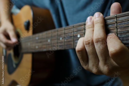Obraz na plátně Close-up of musician with acoustic guitar