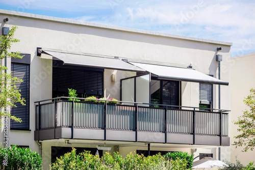 Balcony Awning of Modern Balcony Apartment. Retractable Balcony Canopy on Double Balconies.