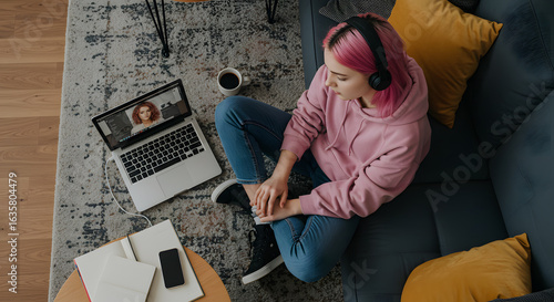 Young hipster teen girl school college student pink hair using laptop computer sit in cozy living room on floor working learning online in internet at home office. Elearning concept. Top view above.