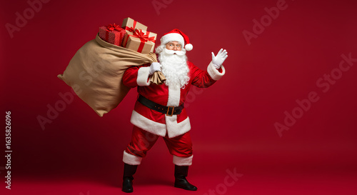 Happy old funny Santa Claus, Saint Nicholas wearing costume holding sack bag with Merry Christmas presents walking delivering xmas gifts standing isolated on red background. Xmas delivery, banner.