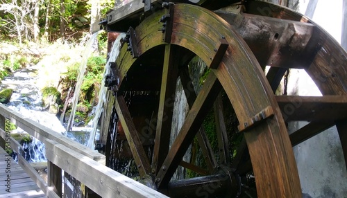 Wooden water wheel powering a mill