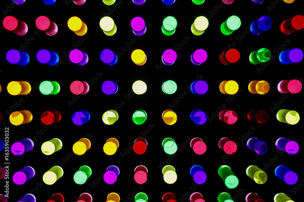 Naklejka premium Backlit plexiglass cylinders in various colors, used by small children to create shapes on panels