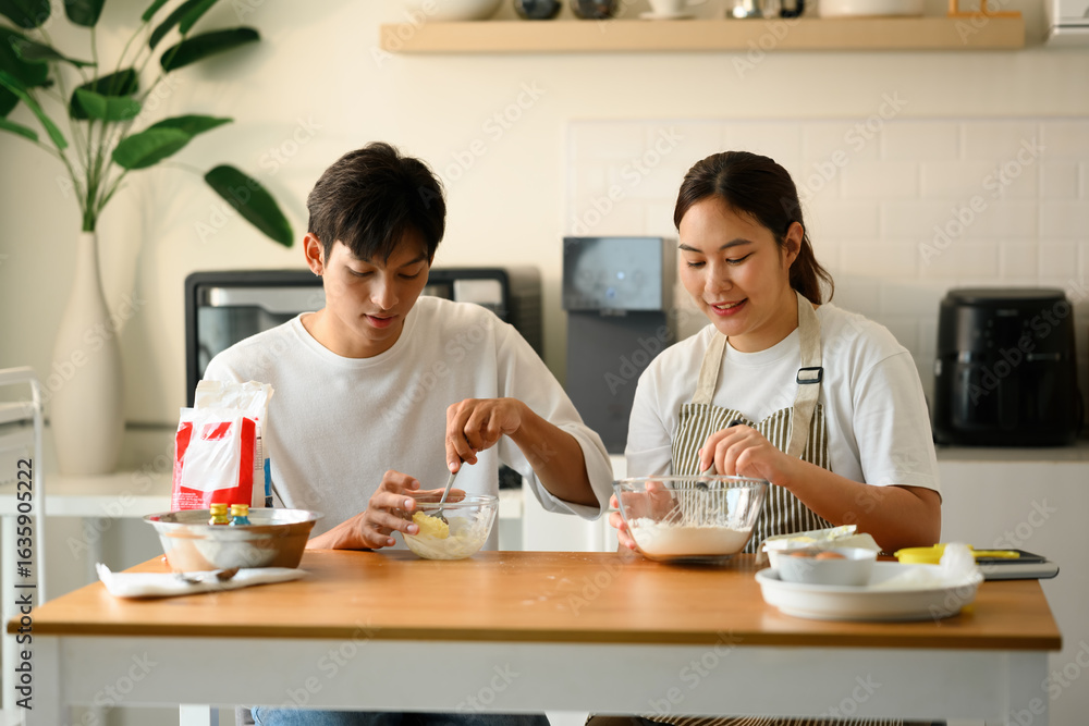 An Asian Couple Preparing Ingredients for Homemade Baking at Home An Asian Couple Preparing Ingredients for Homemade Baking at Home