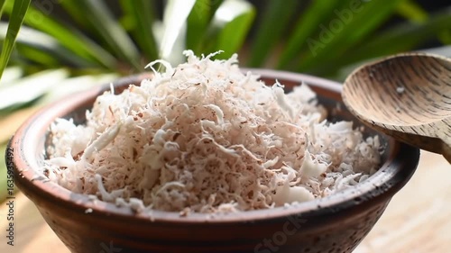 Grated Coconut in Rustic Bowl with Greenery