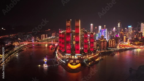 Aerial hyperlapse, dronelapse video of Chongqing at nighttime, timelapse revealing glowing urban landscape, china drone lapse of illuminating skyscrapers and river transportation