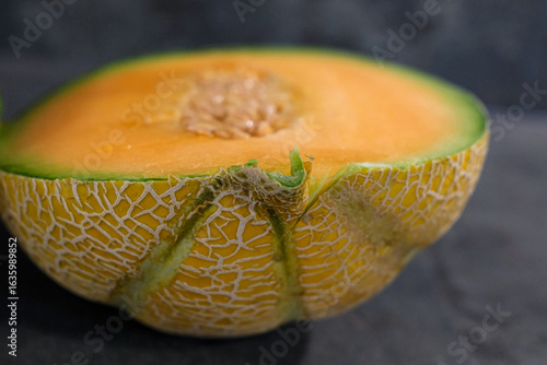 Cuadro en lienzo Ripe cantaloupe cut in half revealing juicy, sweet flesh and textured rind