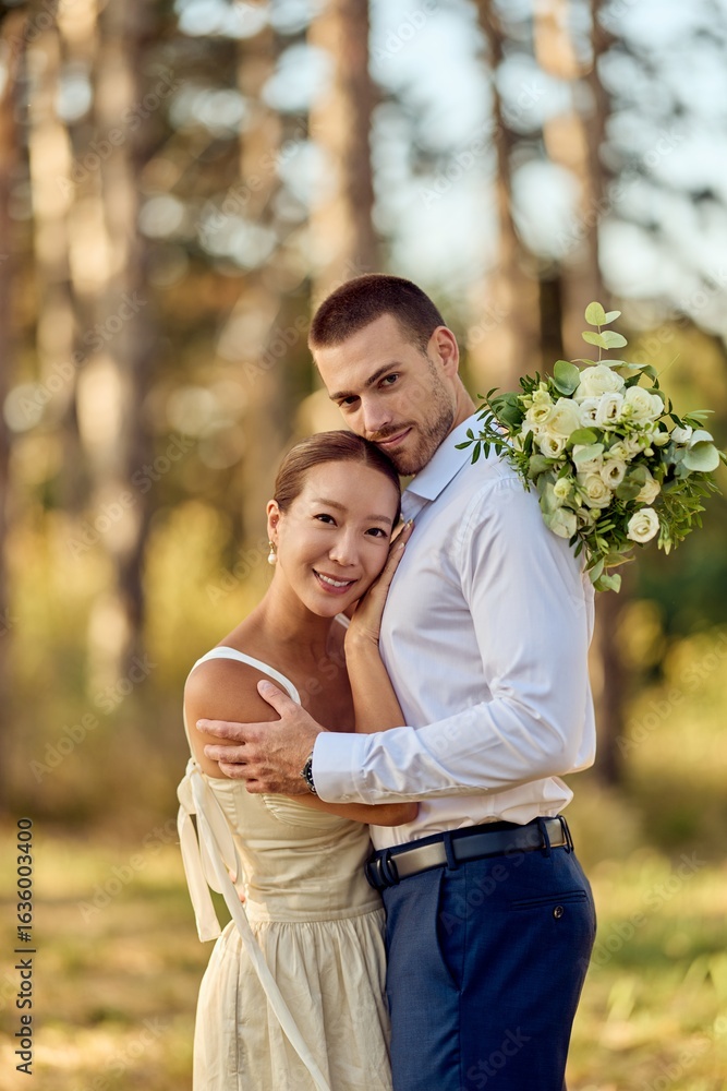 Fototapeta premium Romantic Couple Embracing in a Serene Outdoor Wedding Portrait