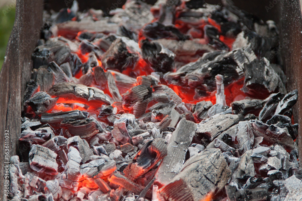 Photo of hot coals. texture of coals on the grill. Edge in the grill Photo of hot coals. texture of coals on the grill. Edge in the grill
