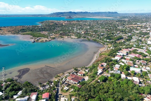 Drone footage of the city of Diego Suarez and the bay - in the background a small conical island off the coast of northern Madagascar