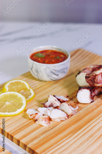 Grilled octopus slices with lemon and dipping sauce