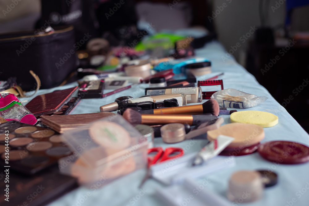 A variety of makeup products and beauty tools scattered across a bed A variety of makeup products and beauty tools scattered across a bed