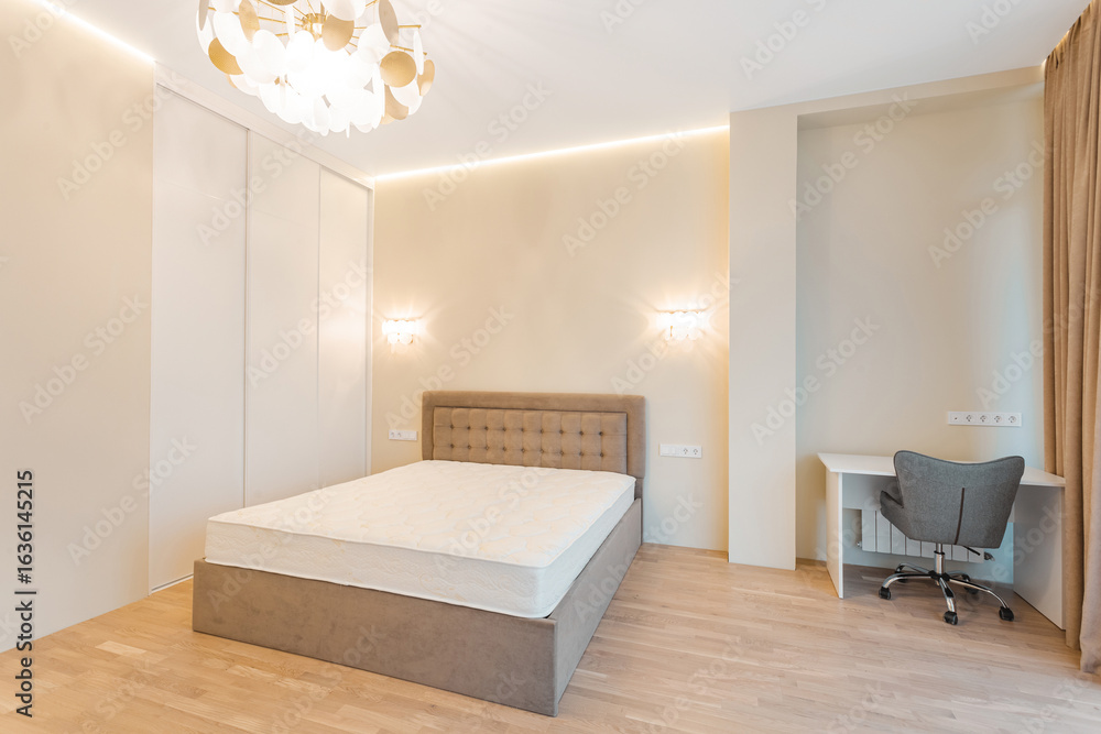 Fototapeta premium Modern bedroom with minimalist design featuring a bed and workspace in a softly lit setting