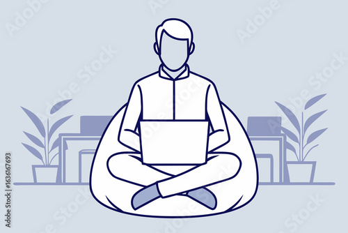 Man working on laptop while sitting cross legged on beanbag chair