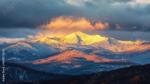 Mountain peaks bathed in golden sunlight at dawn.