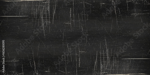 Abstract textured background with a dark, predominantly black and gray color palette and Black scratched grunge background with distressed film texture.