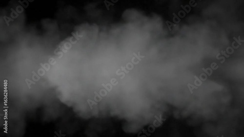 Gray smoke puffs billow against a black background diffused and ethereal