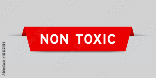 Red color inserted label with word non toxic on gray background