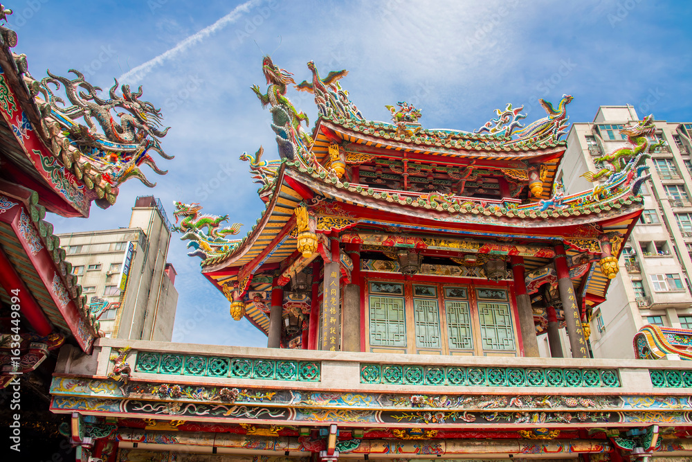 Fototapeta premium The view of Lungshan Temple in Taipei’s Wanhua District (also known as Monga) features traditional Chinese architecture with intricately carved wooden beams, colorful. 