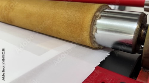 fabric and print paper enter the roll press heat transfer machine, sulimation process at manufacture