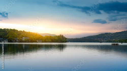 Beautiful Lake Scenery with Sunset Glow Over Calm Water