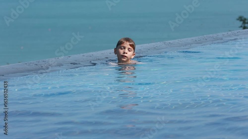 Wallpaper Mural Preschool child in swimming pool, enjoying happy family summer vacation on the beach and in resort, swimming and playing in the water Torontodigital.ca