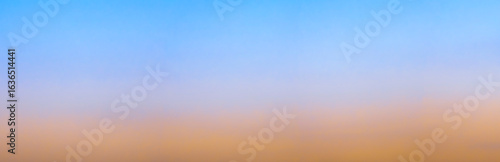 Blurred blue and orange gradient creating a dreamy sky background