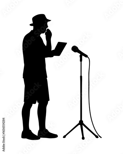 Silhouette of a man in a hat speaking into a microphone while holding a tablet
