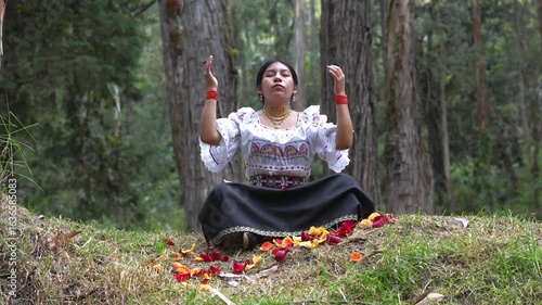 Indigenous woman performing ritual in forest