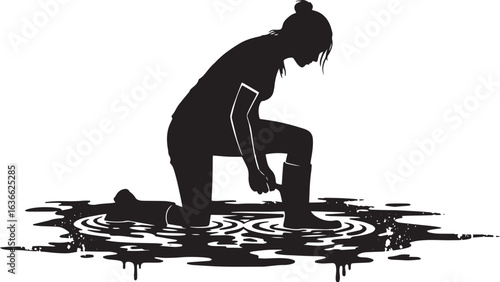 Silhouette of a woman kneeling and adjusting her boot in a puddl