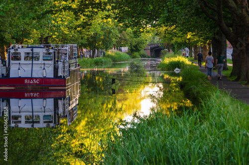 Photography Scenic View of Grand Canal in Dublin with Boat and Lush Greenery