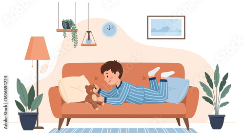 Boy Relaxing In Pajamas At Home With Teddy Bear On Couch