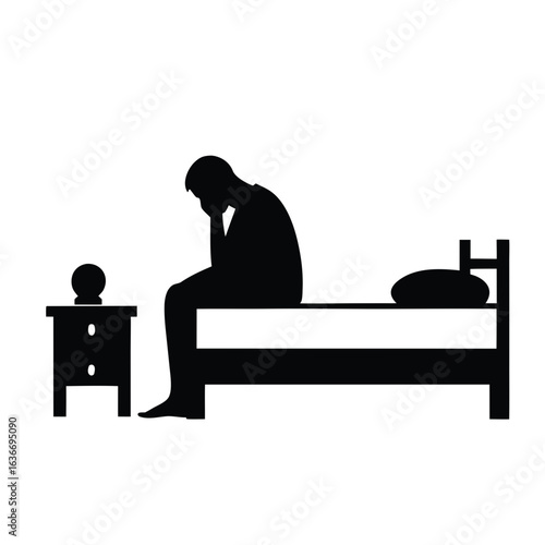 Man sitting on bed feeling sad silhouette