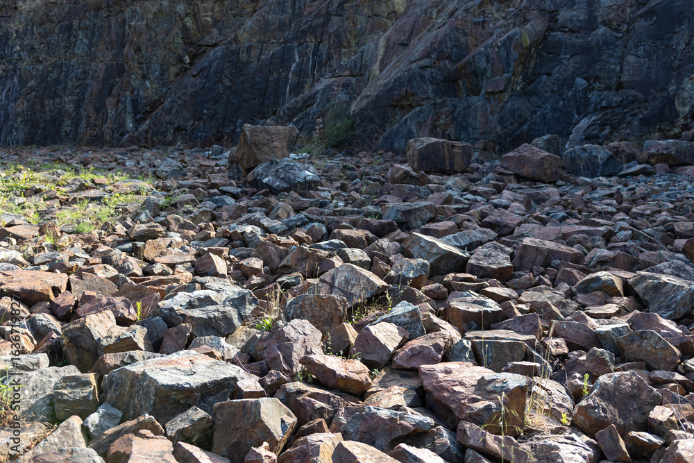 Fototapeta premium Rocky background forming an arid landscape at the foot of a mountain