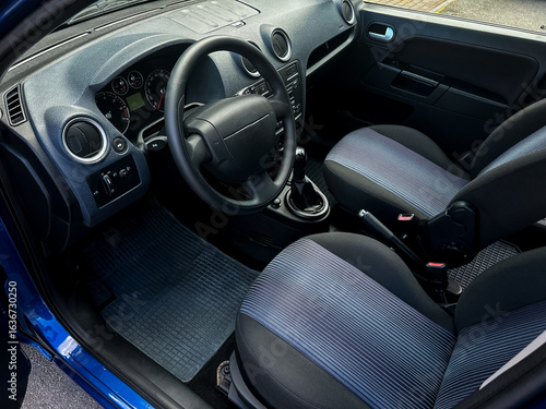 Wallpaper Mural Modern Car Interior View Featuring a sleek and stylish dashboard complemented by comfortable and welldesigned seats, all showcased within a vibrant blue vehicle that represents contemporary design Torontodigital.ca