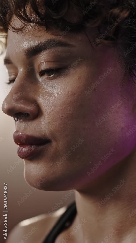 Beautiful confident Caucasian redhead sportswoman drinking water after heavy workout in smokey gym Beautiful confident Caucasian redhead sportswoman drinking water after heavy workout in smokey gym