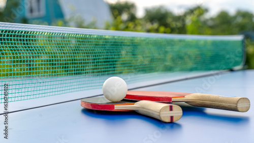 Table tennis rackets on a tennis table in nature