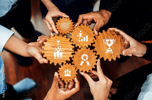 A dynamic image showcasing hands of professionals holding gears adorned with symbols of teamwork and achievement, symbolizing collaboration and shared goals in a business setting. Amity
